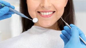 smiling teeth showing dental hygienist working