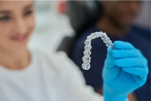 dental technician holding an Invisalign retainer