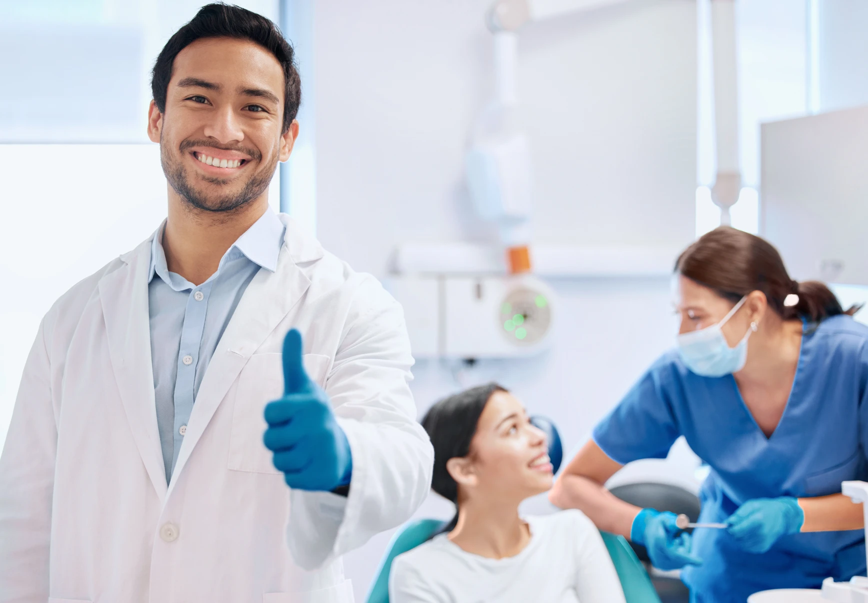 dentist in dental office giving a thumbs up