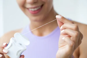women using dental floss